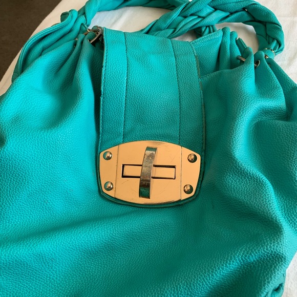 CharmingCharlie’s teal oversized bag,braided strap